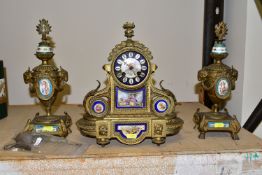 A FRENCH STYLE GILT METAL CHIMING MANTLE CLOCK, hand painted porcelain dial and inset plaques,