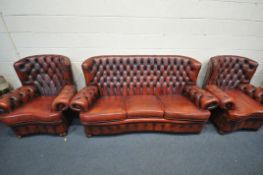 AN OXBLOOD THREE PIECE CHESTERFIELD SUITE, comprising a three seater sofa, length 202cm, and a