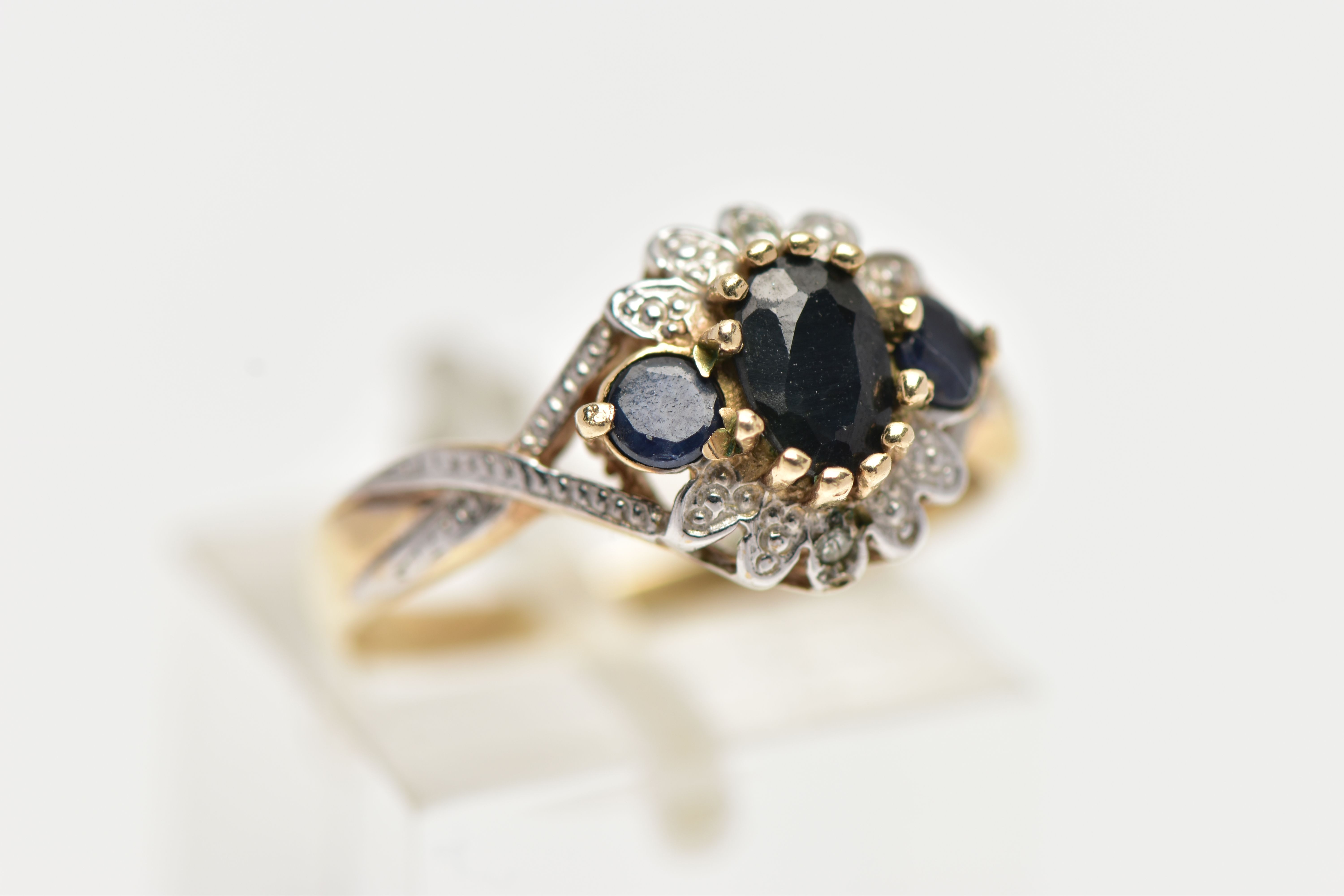 A 9CT GOLD CLUSTER RING, of a circular form, set with an oval and two circular cut blue sapphires, - Image 4 of 4