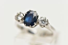 AN 18CT WHITE GOLD SAPPHIRE AND DIAMOND TRILOGY RING, centring on an oval cut deep blue sapphire,