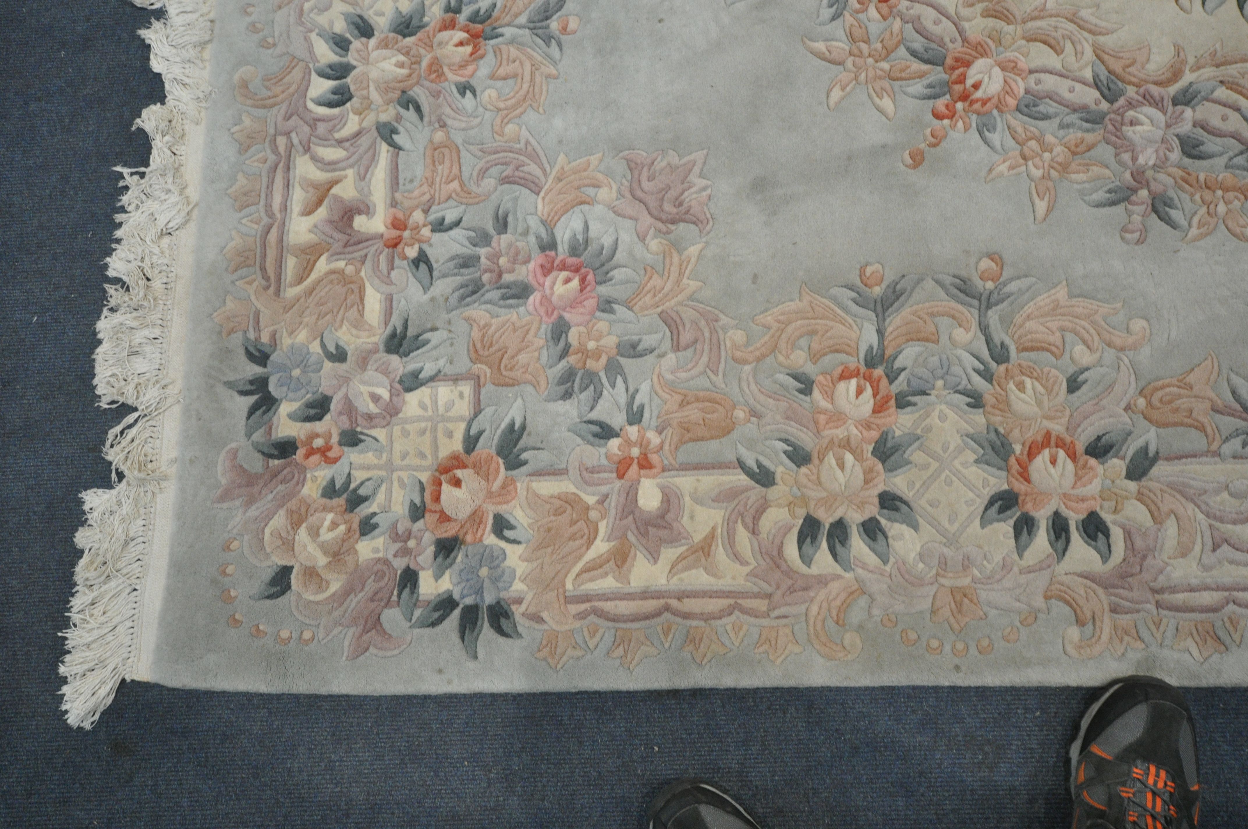 A TEAL CHINESE WOOLEN RUG, with floral border and central design, 284cm x 186cm (condition - in need - Image 2 of 3