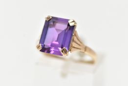 A 9CT GOLD AMETHYST RING, featuring a double four claw set, rectangular cut amethyst, raised
