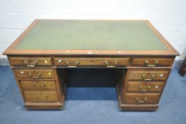 A 20TH CENTURY DESK, with green leather writing surface, nine assorted drawers, length 153cm x depth