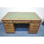 A 20TH CENTURY DESK, with green leather writing surface, nine assorted drawers, length 153cm x depth
