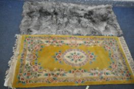 A CHINESE YELLOW RUG, 160cm x 77cm, and faux fur rug (2)
