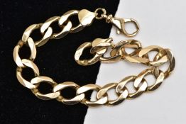 A YELLOW METAL CURB LINK BRACELET, a wide flat curb link bracelet, approximate width 9.6mm, fitted