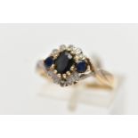 A 9CT GOLD CLUSTER RING, of a circular form, set with an oval and two circular cut blue sapphires,