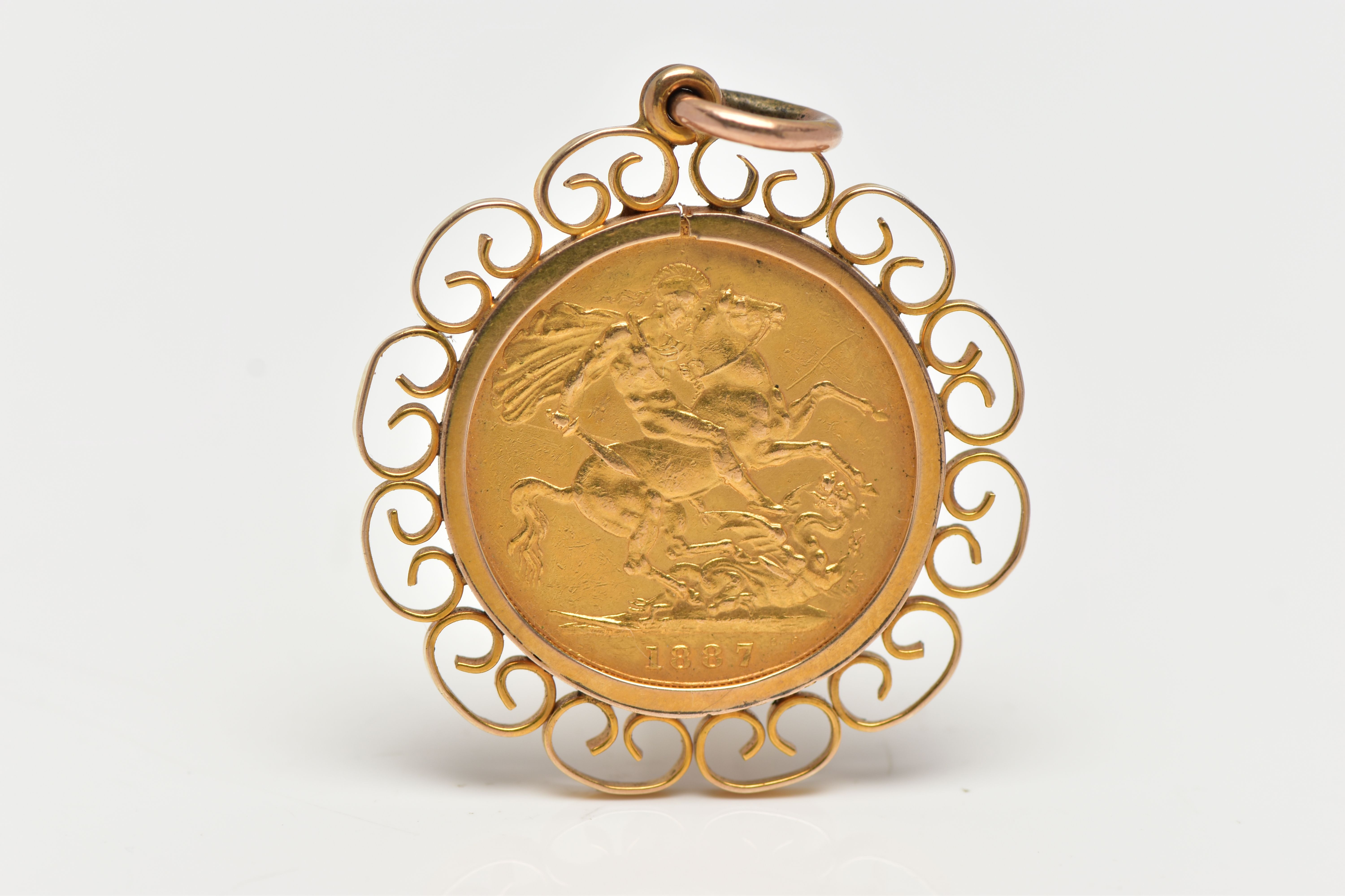A FULL SOVEREIGN COIN PENDANT, the coin dated 1887, within an openwork scroll surround, pendant
