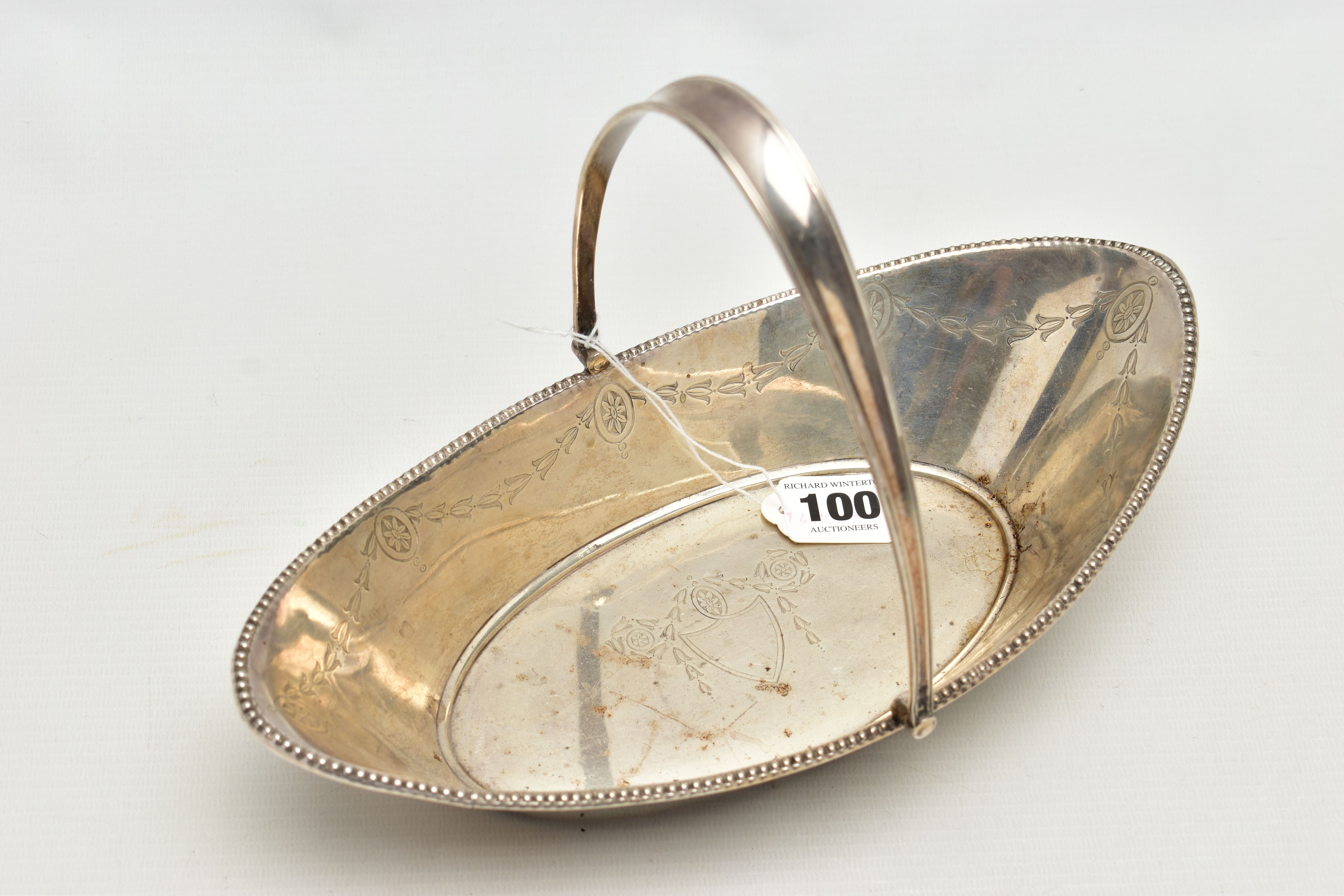 A SILVER BASKET, a boat shaped dish, engraved with floral detail, fitted with a tapered handle,
