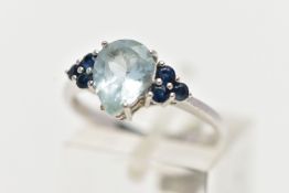 A 9CT WHITE GOLD GEM SET RING, set with a pear cut aquamarine, flanked each side with three circular