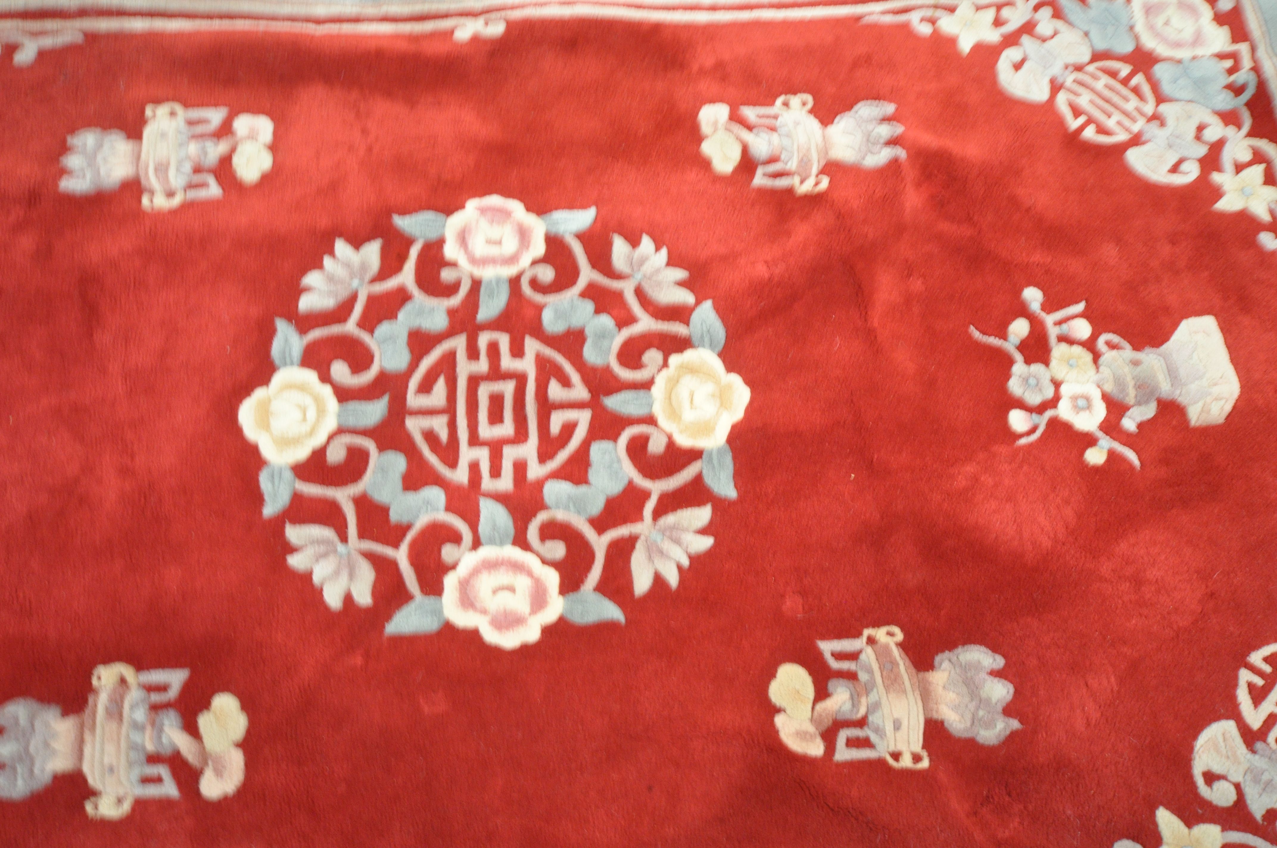 A RED GROUND WOOLEN RUG, with a multi strap border, and a central floral design 276cm x 190cm ( - Image 3 of 4