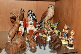 A GROUP OF EIGHT ASSORTED GOEBEL FIGURES AND FIVE CARVED WOOD ANIMALS, comprising a carved wood