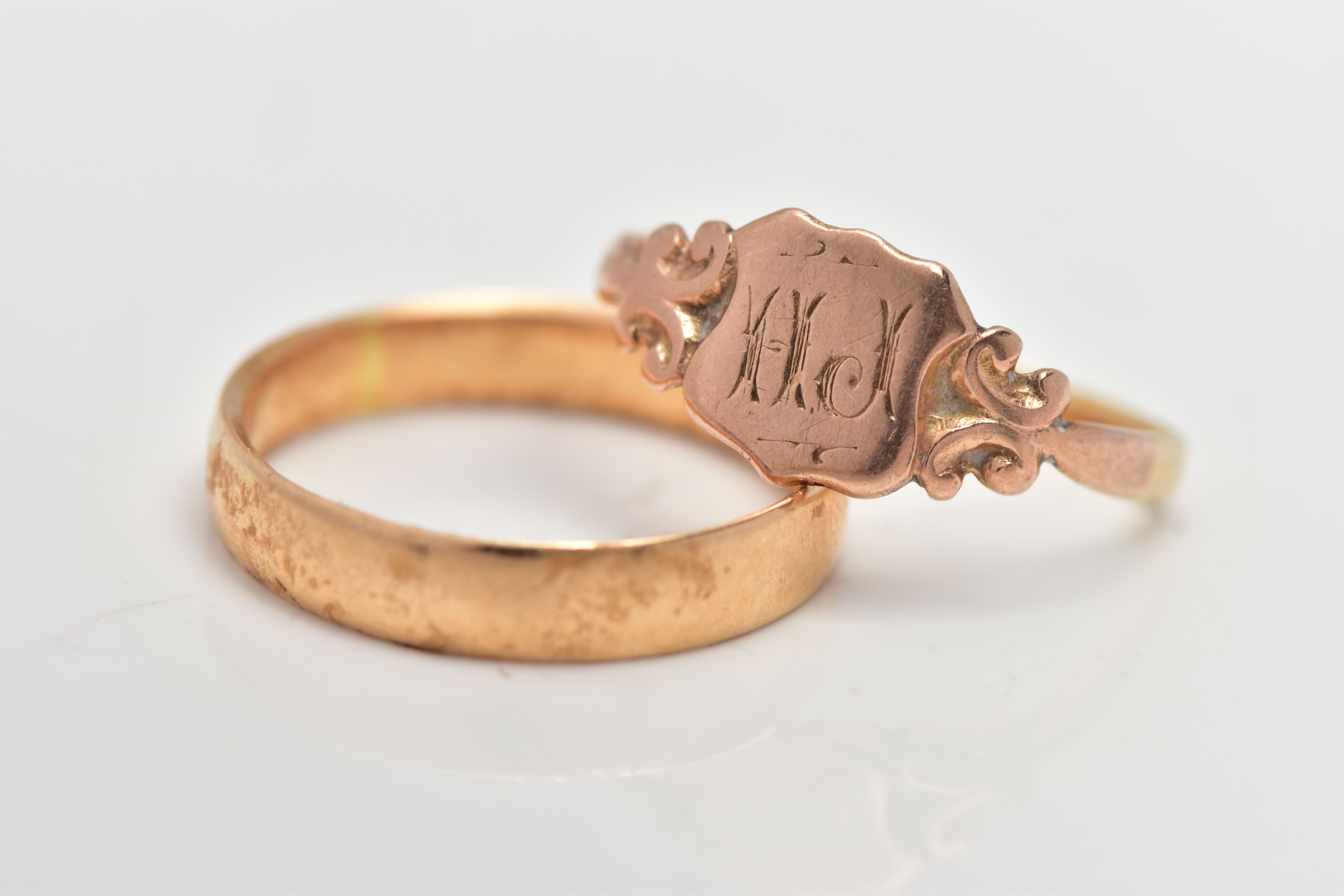 AN 18CT GOLD BAND RING AND A ROSE GOLD TONE SIGNET RING, plain polished band, approximate band width