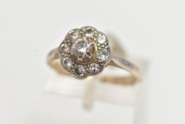 A WHITE METAL DIAMOND CLUSTER RING, of a flower shape, set with nine round brilliant cut diamonds,