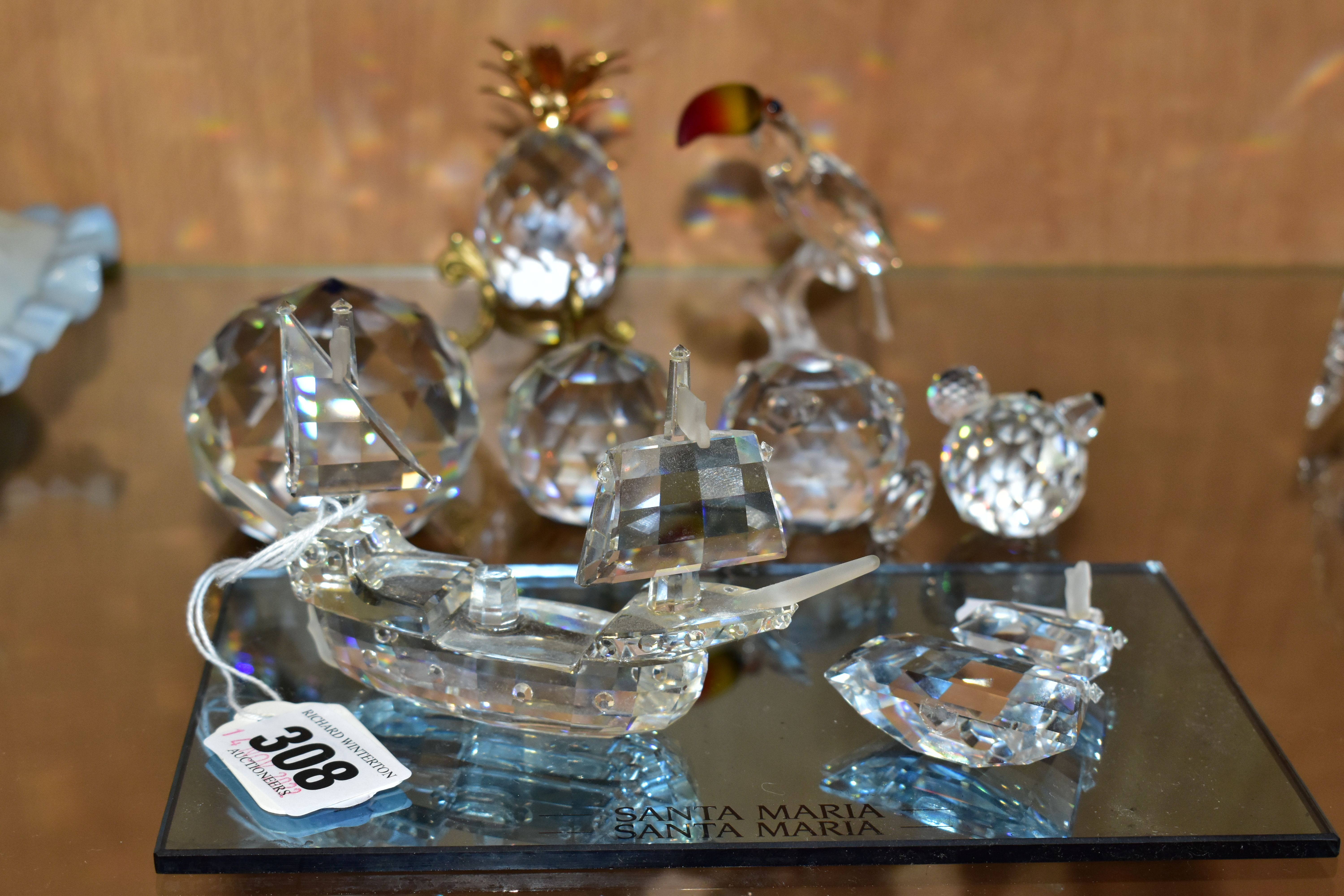 FOUR SWAROVSKI CRYSTAL ORNAMENTS AND TWO COLOURED CRYSTAL PAPERWEIGHTS, comprising a Santa Maria -