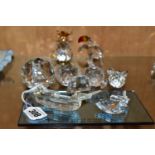 FOUR SWAROVSKI CRYSTAL ORNAMENTS AND TWO COLOURED CRYSTAL PAPERWEIGHTS, comprising a Santa Maria -