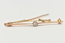 A YELLOW METAL DIAMOND BAR BROOCH, designed with a milgrain set old cushion cut diamond, estimated