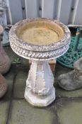 A MODERN COMPOSITE BIRD BATH with a balustered base and a 38cm diameter circular bowl height 69cm