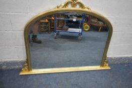 A GILT FRAMED BEVELED EDGE OVERMANTEL MIRROR, the top with foliate design, length 147cm x height