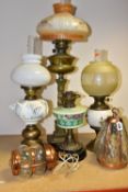 FOUR VICTORIAN OIL LAMPS, comprising an Eltex oil lamp with a brass base and fittings a white