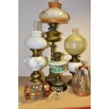 FOUR VICTORIAN OIL LAMPS, comprising an Eltex oil lamp with a brass base and fittings a white