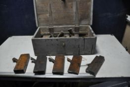 A VINTAGE WOODEN TOOLBOX containing wooden smoothing, coffin and moulding planes width 66cm depth