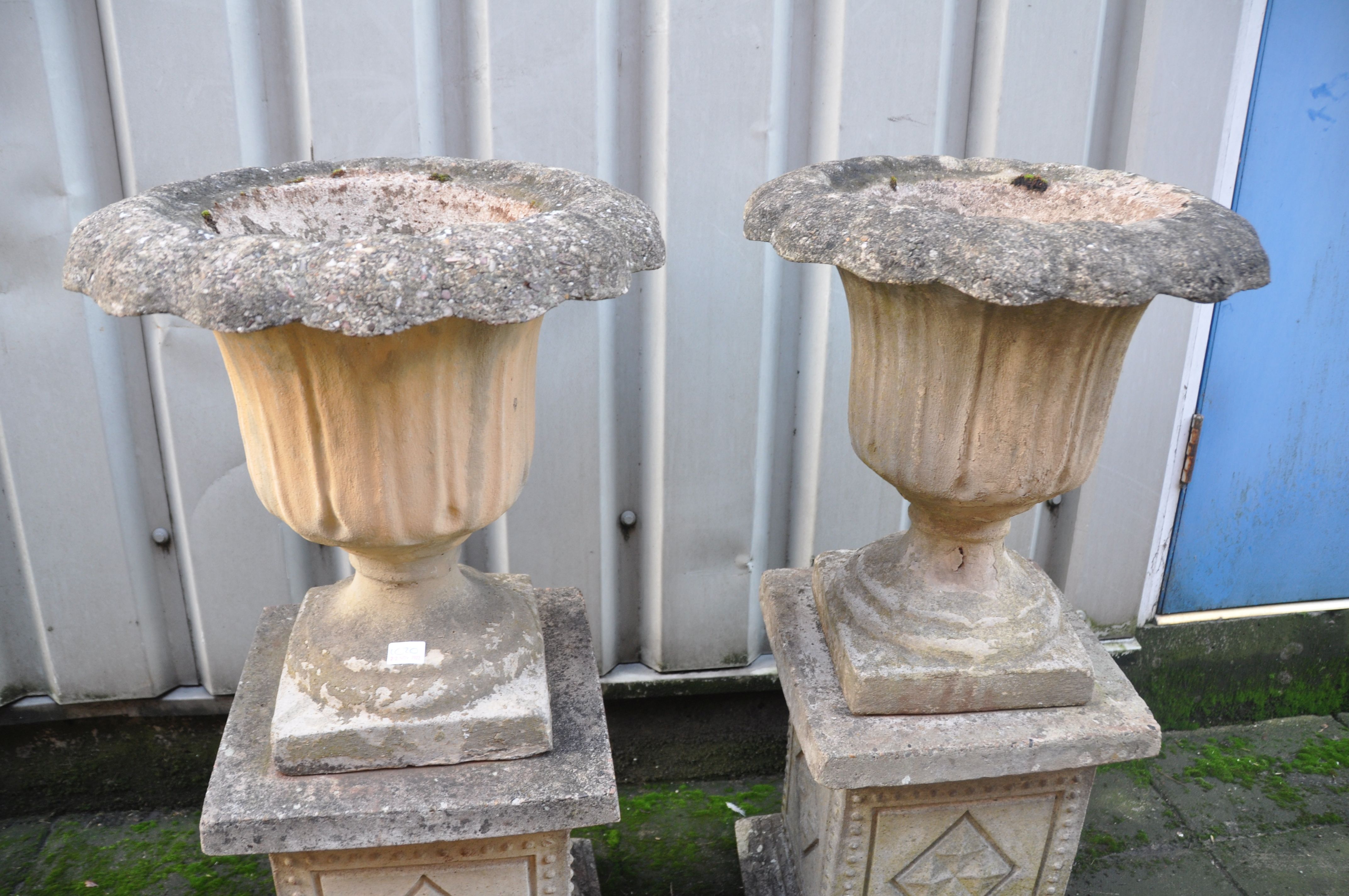 A PAIR OF COMPOSITE GARDEN URNS with acanthus leaf detailing to urn standing on square columns - Image 2 of 2
