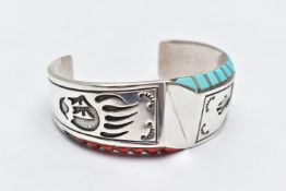 A WHITE METAL BANGLE, a cuff Navajo style bangle, embossed with a bear claw and bear design, set