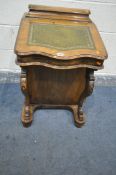 A VICTORIAN WALNUT DAVENPORT, with stationary compartment, behind a lid with a green writing