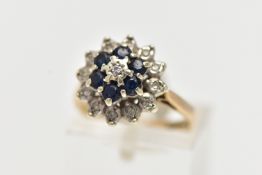 A 9CT GOLD SAPPHIRE AND DIAMOND CLUSTER RING, raised flower shape cluster, to the center sits a