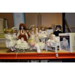 A COLLECTION OF TEN PORCELAIN COLLECTABLE DOLLS, to include a musical baby in a wooden highchair (