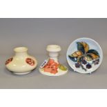 THREE PIECES OF MOORCROFT POTTERY, comprising a squat vase in a 'Flaminian Revival' design on a