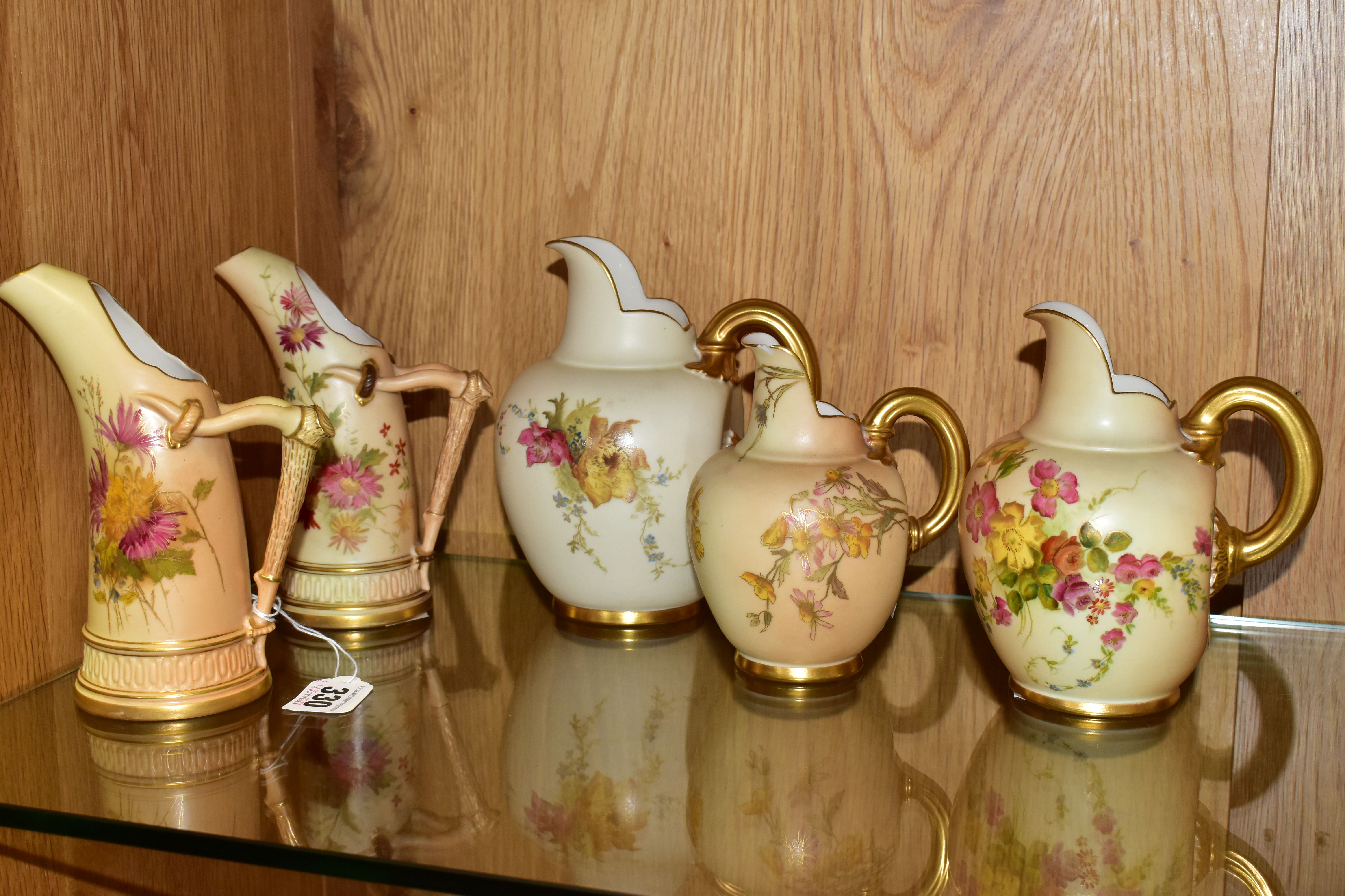 FIVE ROYAL WORCESTER BLUSH IVORY JUGS, each printed and tinted with flowers, with printed purple