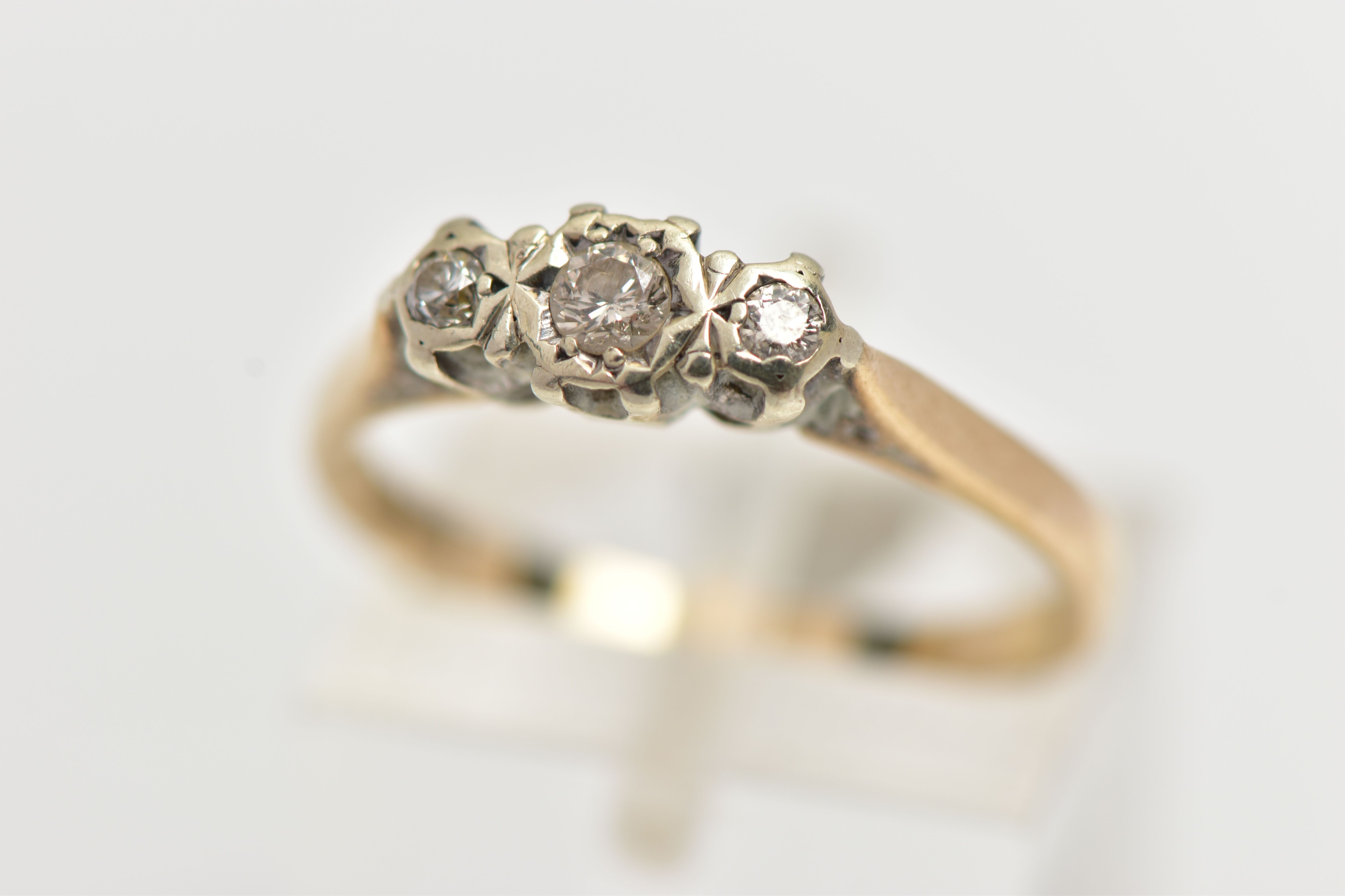A 9CT GOLD THREE STONE DIAMOND RING, three round brilliant cut diamonds prong set in white metal