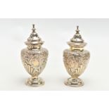 TWO VICTORIAN SILVER PEPERETTES, baluster form with embossed floral detailing, approximate