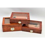 THREE 'GERMANUS' AMBOYNA CIGAR HUMIDOR BOXES, two shallow wooden boxes with an open top glass panel,