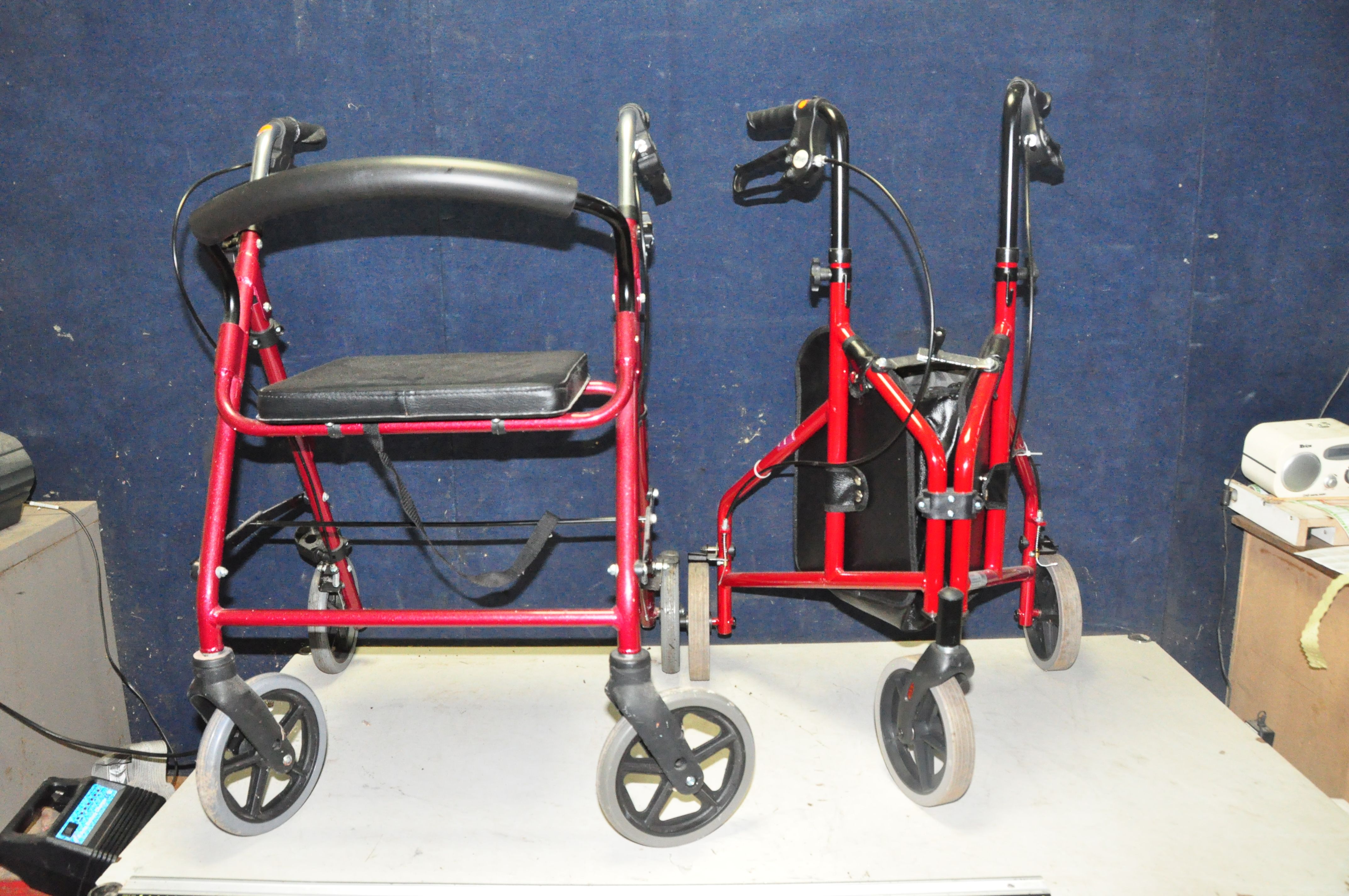 A DRIVE AND A COOPERS TRAVELATOR, both folding, one with a seat and the other with central bag (2)