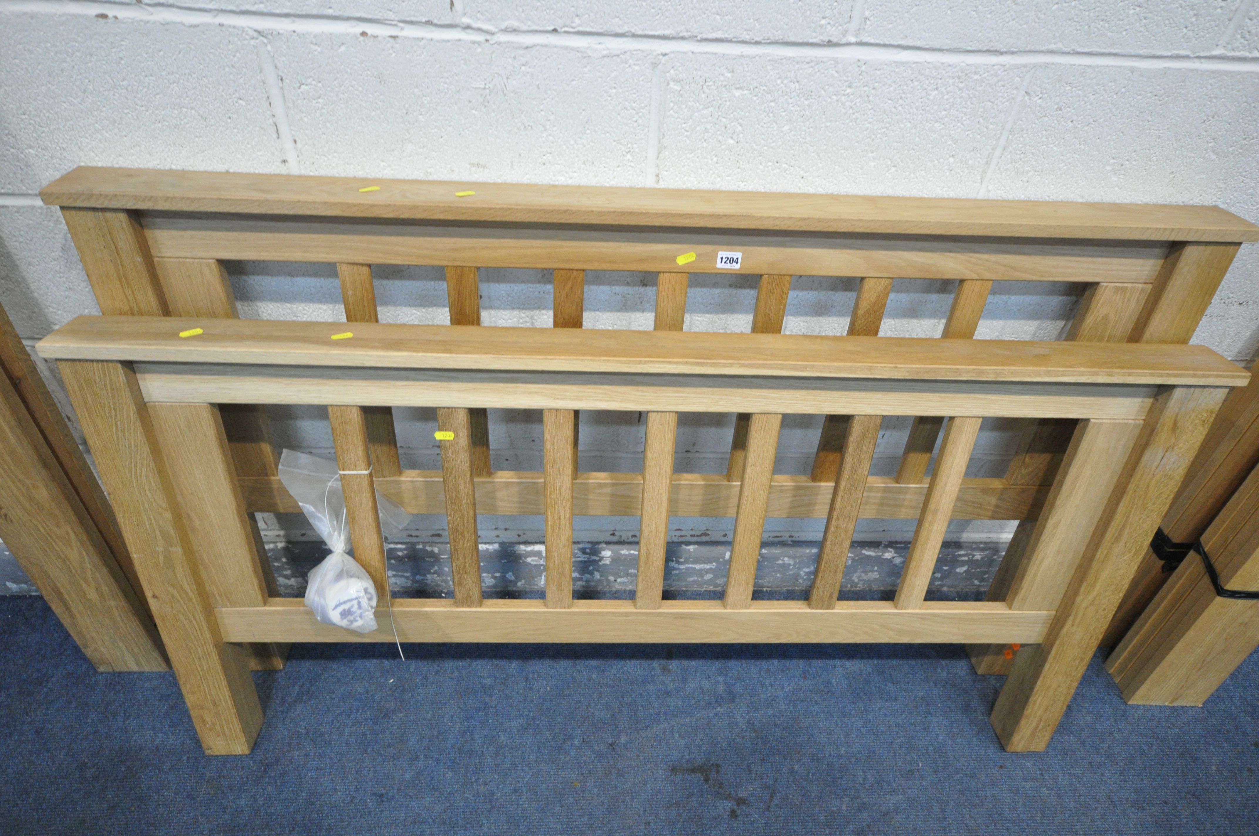 A SOLID OAK 4FT6 BEDSTEAD (condition - dismantled but bolts appear present, discoloration to - Image 2 of 3