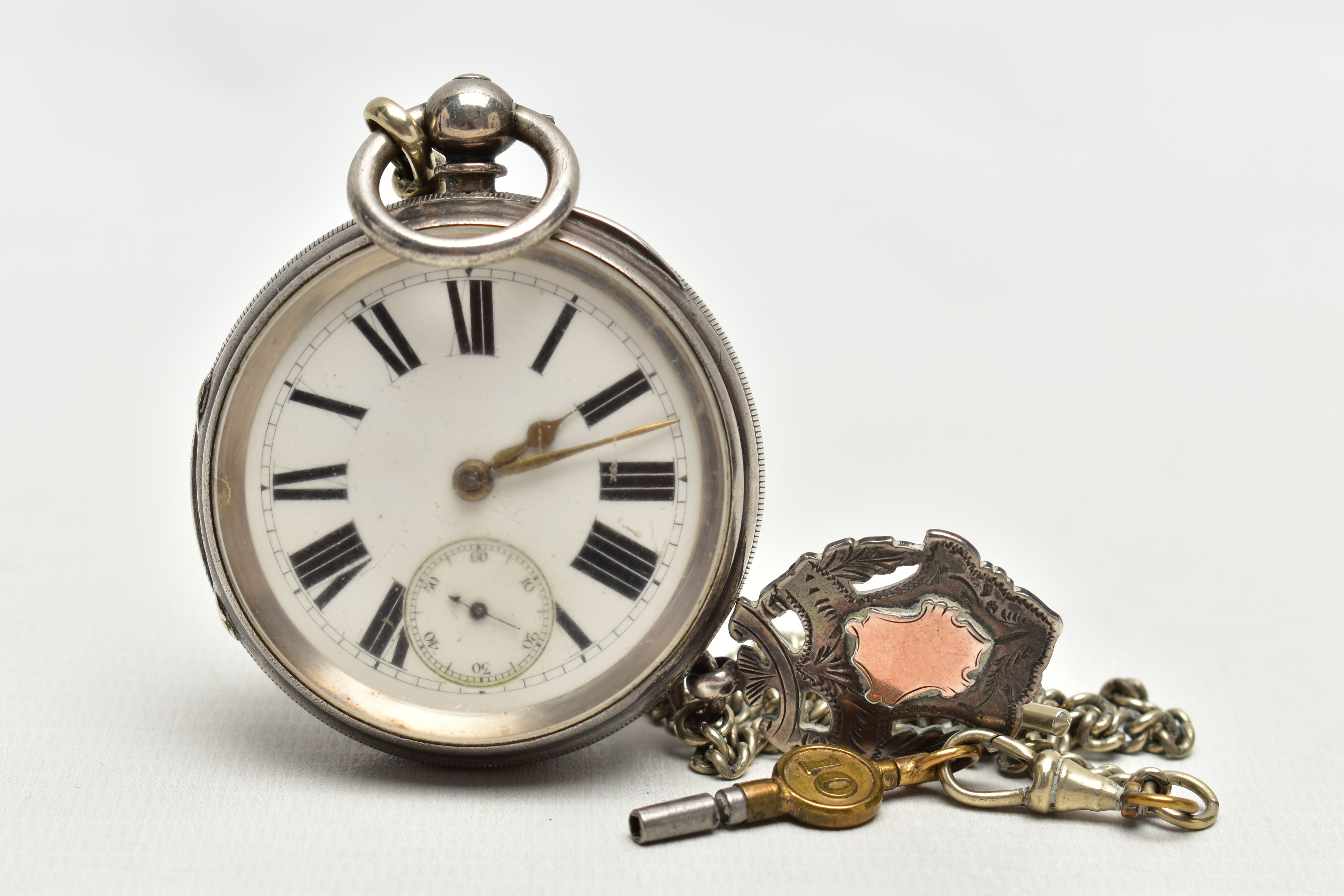 A SILVER OPEN FACE POCKET WATCH WITH ALBERT CHAIN AND FOB, key wound pocket watch featuring a