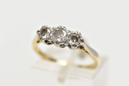 A YELLOW METAL THREE STONE DIAMOND RING, set with three illusion set old cut diamonds, estimated