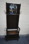 A 20TH CENTURY OAK HALL STAND, the top with a mirror with canted corners, four metal coat hooks, a