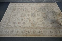 A LARGE CREAM FLORAL RUG, 293cm x 202cm, a red and cream floral rug, a Chinese rug, and a half