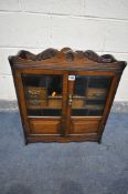 A 20TH CENTURY OAK SMOKERS CABINET, with two bevelled glass doors, enclosing six drawers, width 55cm