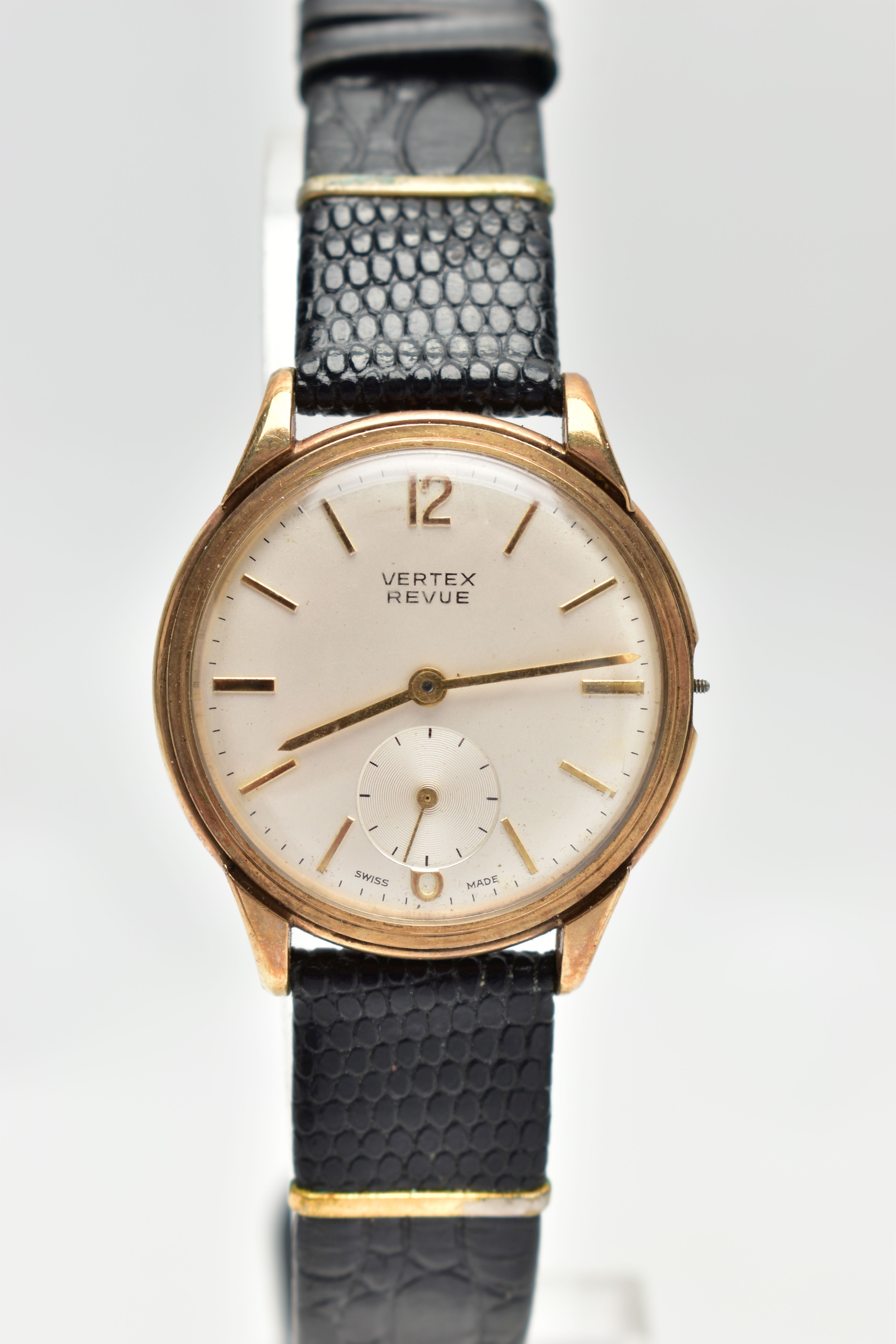 A 9CT GOLD 'VERTEX REVUE' WRISTWATCH, an AF hand wound movement, round champagne dial, signed '