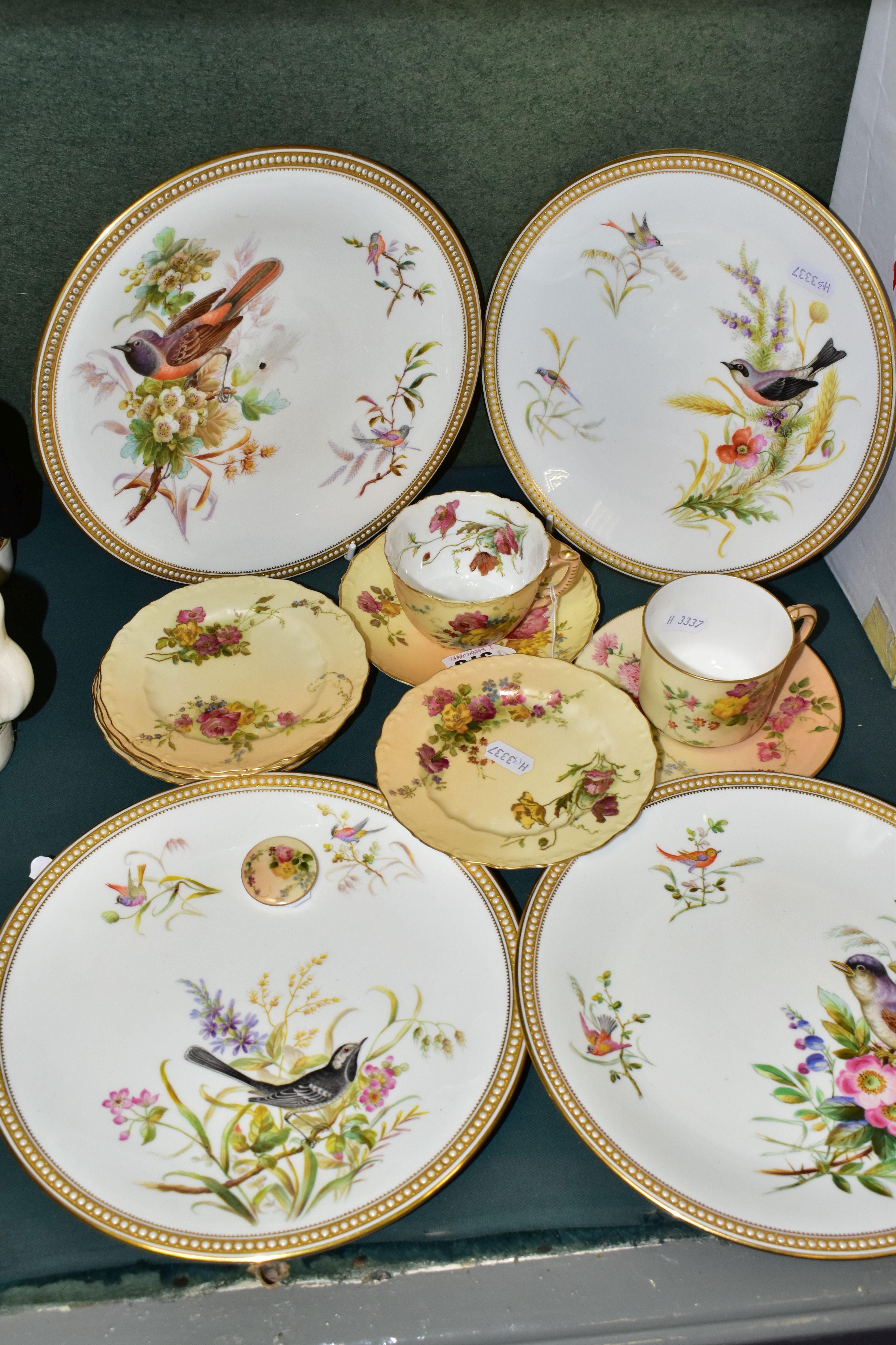 A GROUP OF ROYAL WORCESTER PORCELAIN, comprising four nineteenth century plates hand painted with