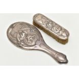 AN EDWARDIAN SILVER MIRROR AND BRUSH, art nouveau design depicting iris flowers and a lady wearing a