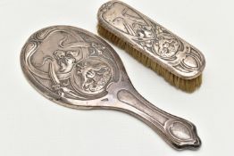 AN EDWARDIAN SILVER MIRROR AND BRUSH, art nouveau design depicting iris flowers and a lady wearing a