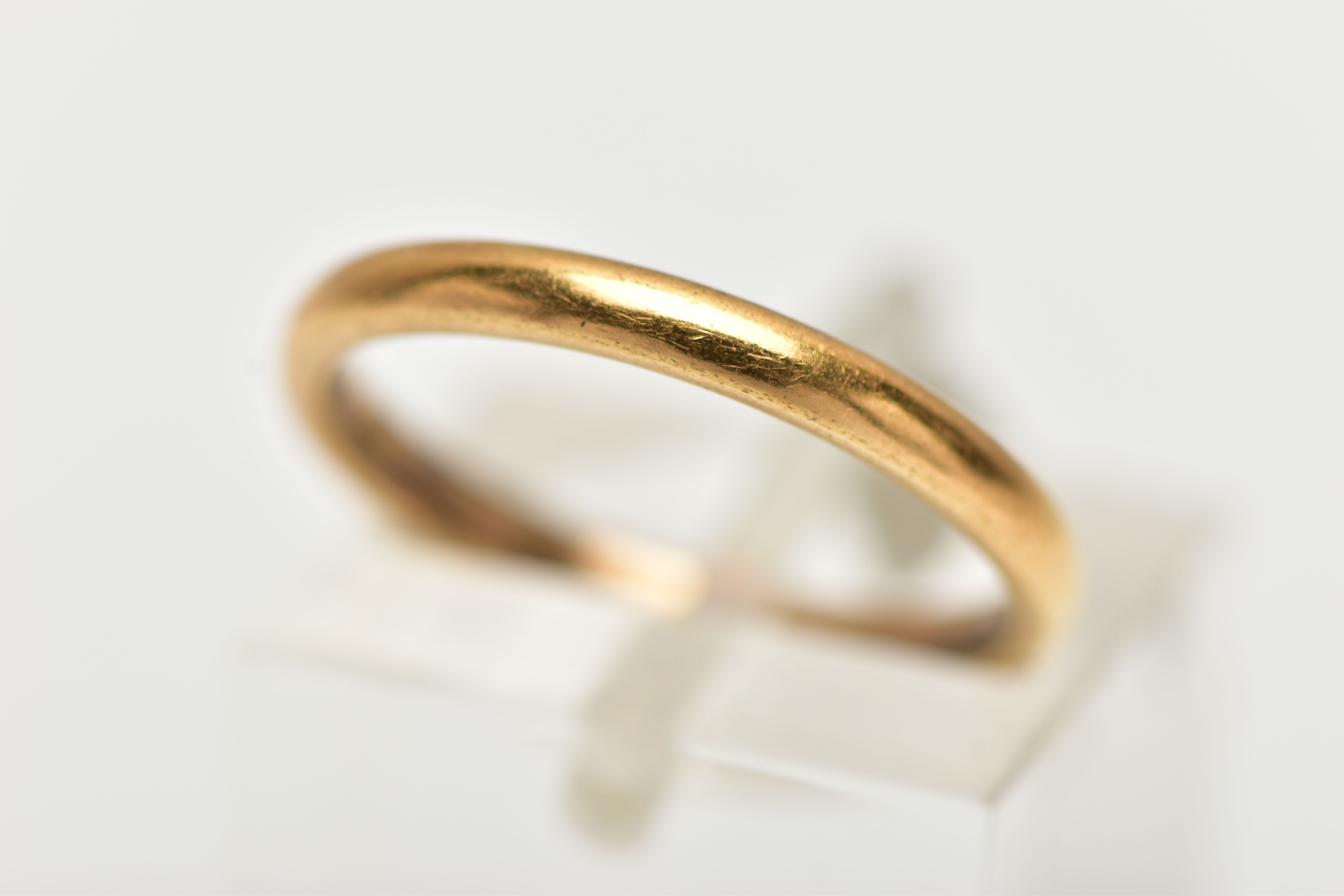 A THIN 22CT GOLD BAND RING, plain polished thin band, approximate width 2.2mm, ring size J,