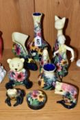 A COLLECTION OF OLD TUPTON WARE, with tube lined flowers on a cream to navy graduating ground, to