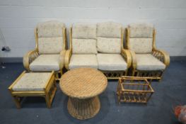 A WICKER FOUR PIECE CONSERVATORY SUITE, comprising a two seater sofa, two armchairs, and a foot